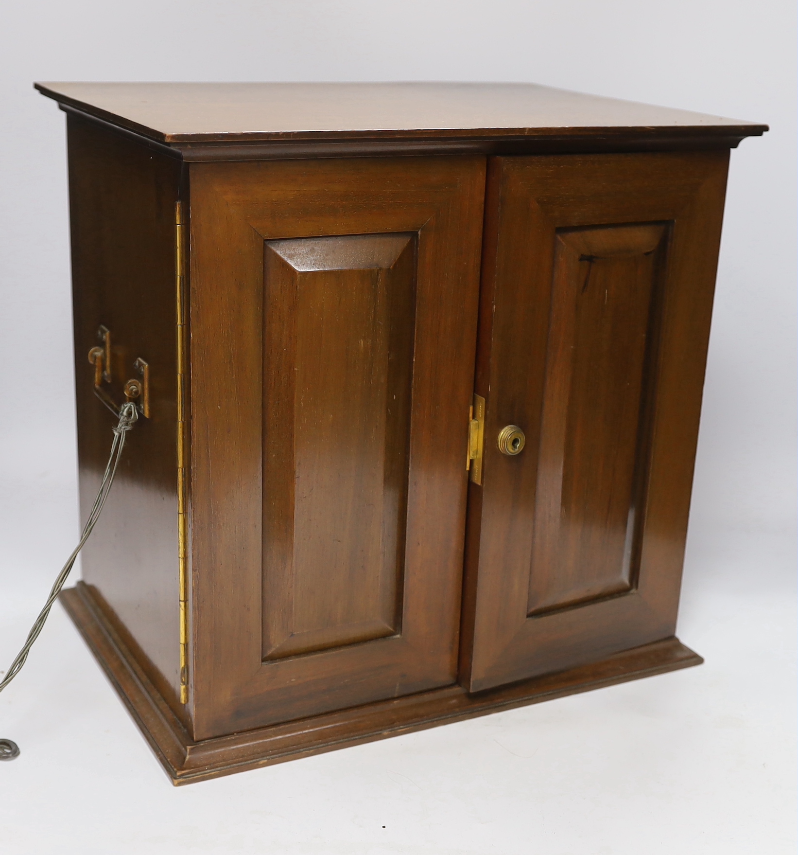 A mahogany smoker's cabinet with tobacco jar and three Jose L Piedra Cuba cigars, 35cm high